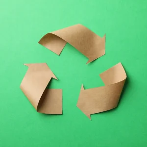 recycling-sign-on-green-background-top-view-2023-11-27-04-51-14-utc.